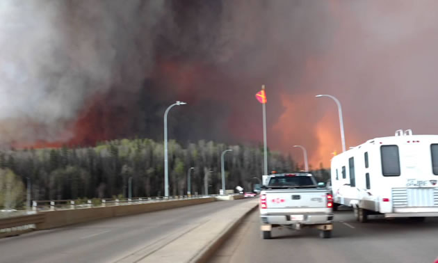 A YouTube photo of a Fort McMurray resident escaping the burning city with trailer in tow.