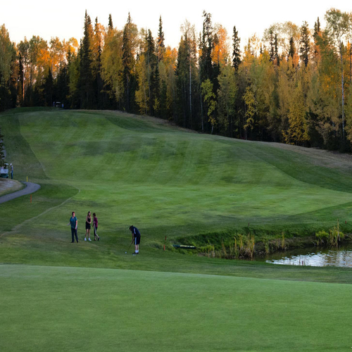 This hole on the Poplar Hills Golf & Country Club in Fort Nelson is lined with trees and has a water hazard.