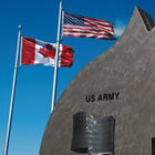 monument along with two flags, for USA and Canada