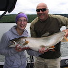 Woman and man holding a very large fish