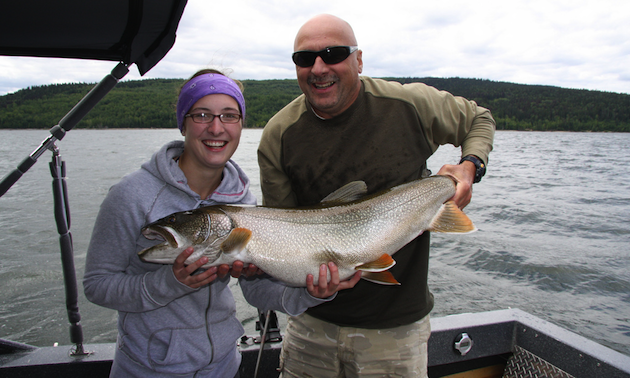 Woman and man holding a very large fish