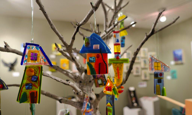 stained glass houses hanging from tree branches