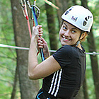 Woman swinging through the trees near Revelstoke