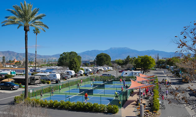 Aerial view of tennis courts, blue sky. 
