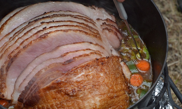 A beautifully cooked ham inside the dutch oven.
