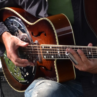 Man playing guitar at Harrison Mills