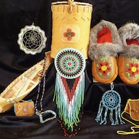 A display of native items, including  beaded moccasons, a miniture canoe, dreamcatcher and a beaded purse  from the Mackenzie Crossroads Museum and Visitor centre at High Level. 