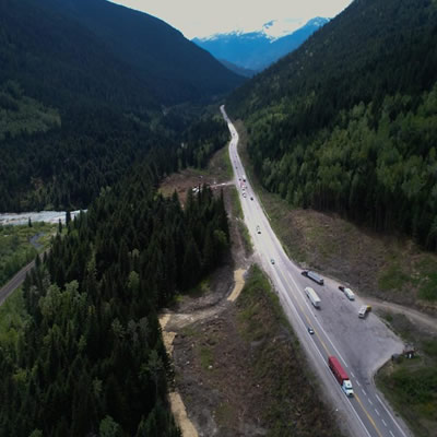 Aerial view of highway through mountains. 