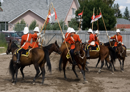 Men on horses perform a musical ride.