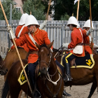 Men on horses perform a musical ride.