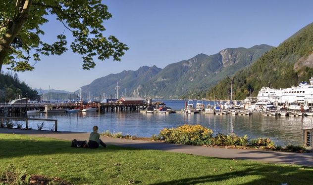 A cruise ship and sailboats are docked in Horseshoe Bay. 
