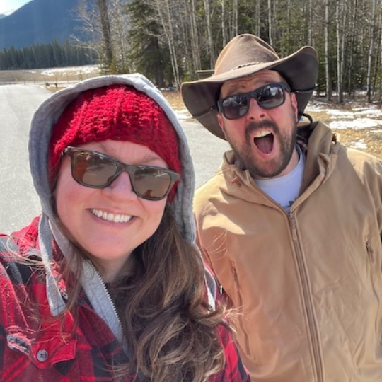 Meghan and Dan standing together and smiling at the camera