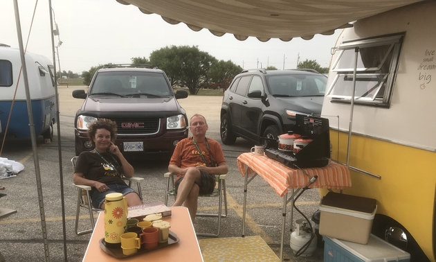 The Sietzemas sitting in front of their Boler