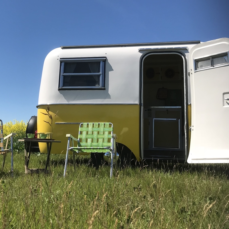 yellow boler with lawn chairs in front