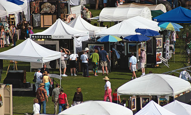 people shopping under vendor tents