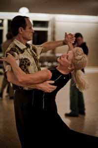 A man and a woman are dancing together.