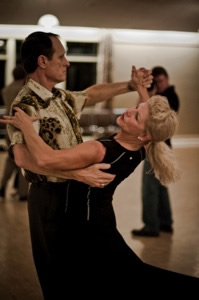 A man and a woman are dancing together.