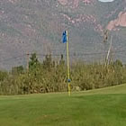 Golf green with mountains in background