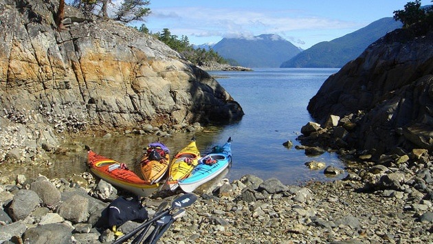 Kayaks are rafted together in a sheltered bay on an island just off of Lund.