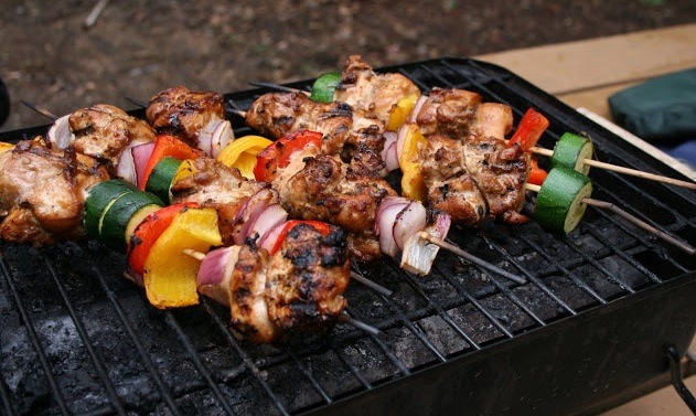 Photo of skewer with meat & red & green peppers.