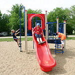 kids playing with a colourful parachute