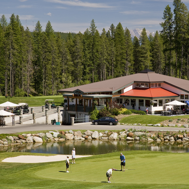 Trickle Creek Golf Course has tree-lined fairways and mountains in the background.