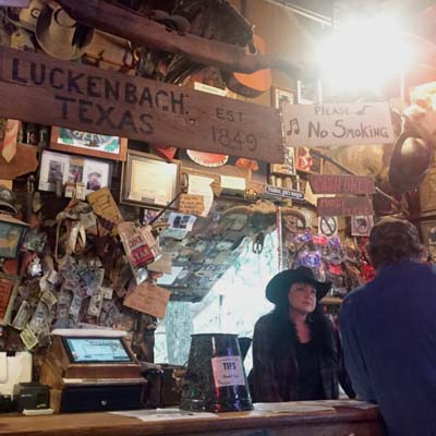 A bartender takes an order at The Luckenbach Bar in Texas.