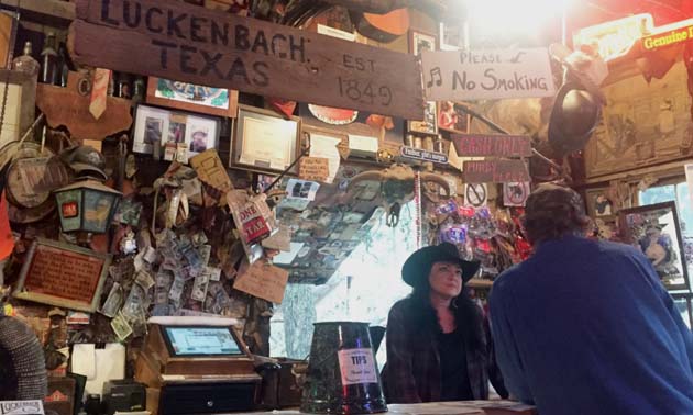 A bartender takes an order at The Luckenbach Bar in Texas.