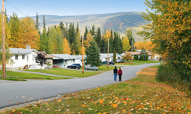 couple walking down a street in autumn