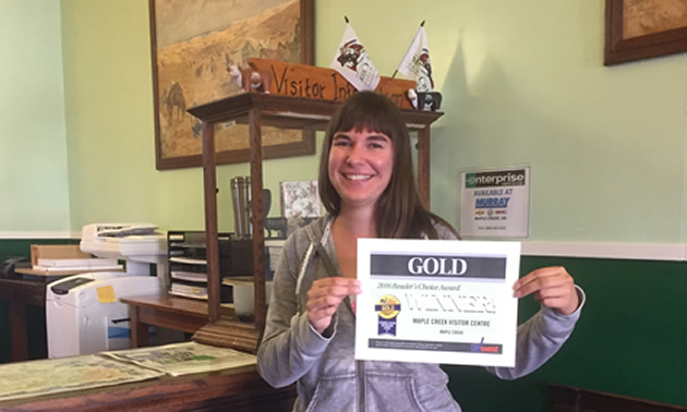 Picture of woman holding RVwest award certificate. 