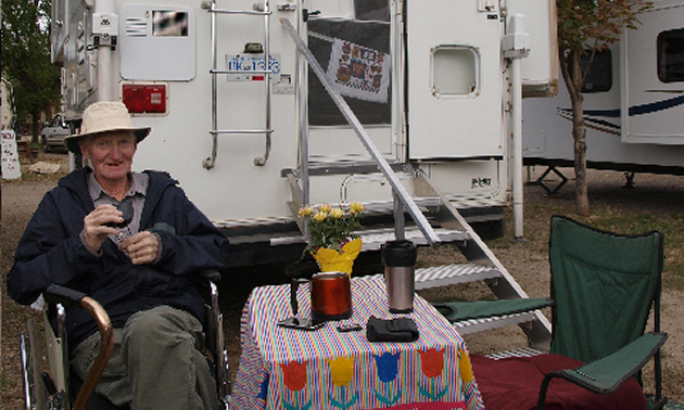 man sitting behind an RV