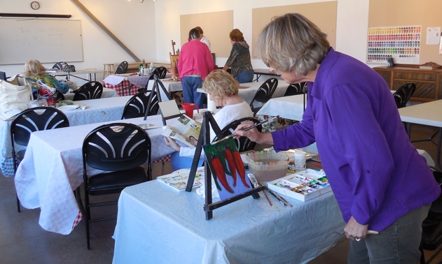 Jan Doherty finishes her acrylic painting at the Mesquite fine arts classroom.