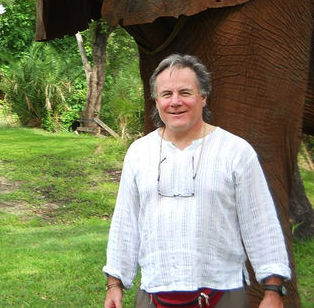 Mike Donovan standing in front of an Elephant.