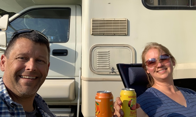 Mike and Gisele Godwin sitting in front of their RV