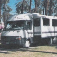 A motorhome with the awning up. 