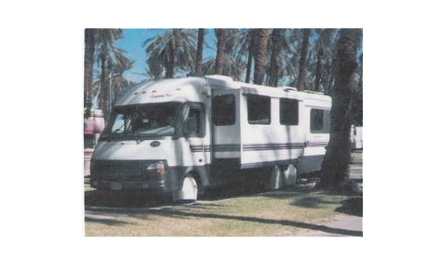 A motorhome with the awning up. 