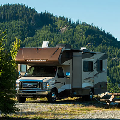 Picture of RV parked by mountainside. 