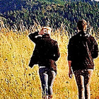 two people walking in a field