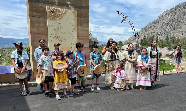 A group of people in First Nations traditional clothing