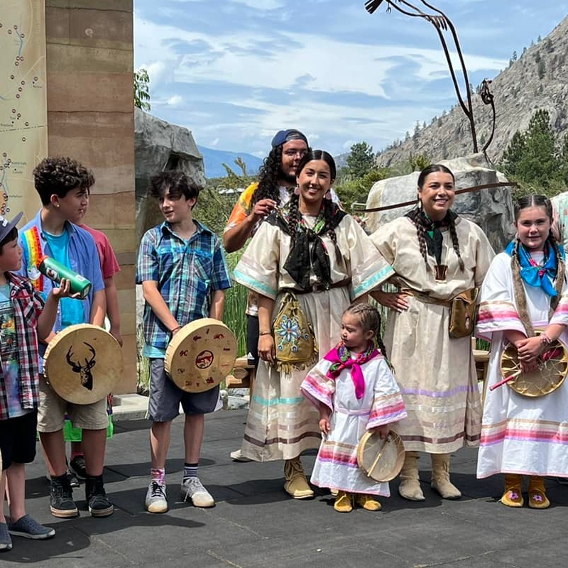 A group of people in First Nations traditional clothing