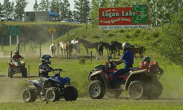 Two people on ATV's. 