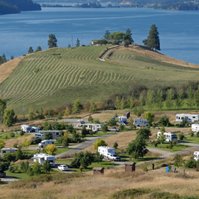 Picture of RVs on hillside overlooking lake. 