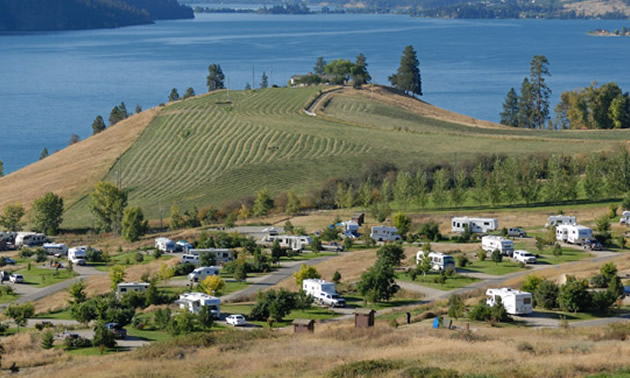 Picture of RVs on hillside overlooking lake. 