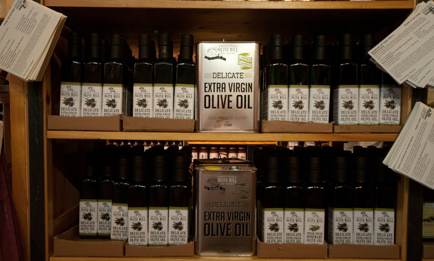 Shelves are lined with containers of olive oil for sale at the Queen Creek Olive Mill.