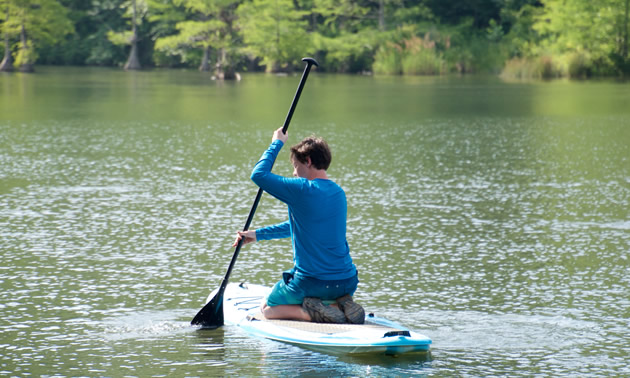 Brenden, 14, paddleboards at Beaver’s Bend State Park in Oklahoma.