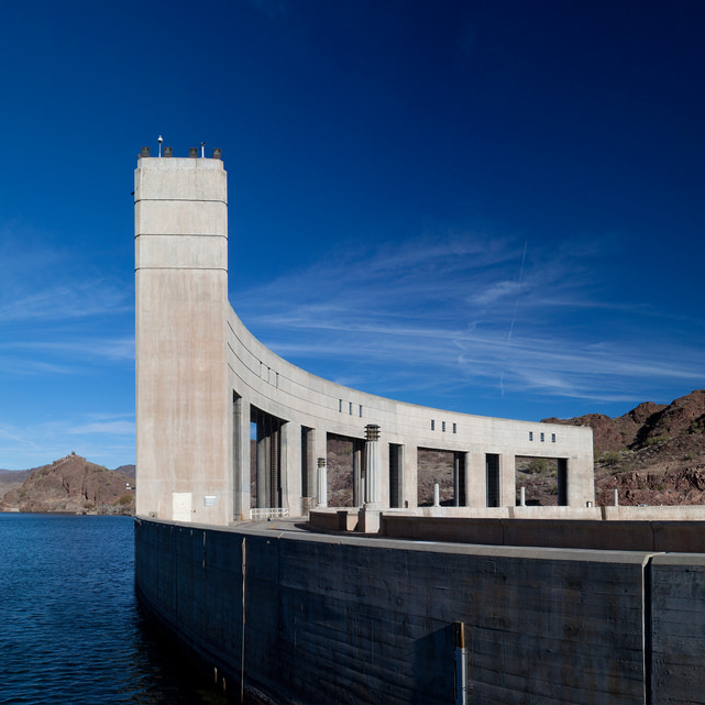 This is a photo of the Parker Dam with blue sky and the blue waters of Lake Havasu.
