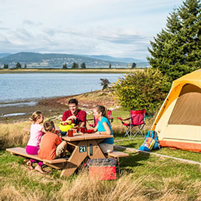 Family camping along a lakeshore. 