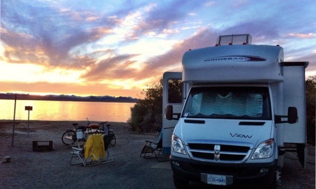 Patrick Tham's RV van with a sunset reflecting on the lake in the background. 