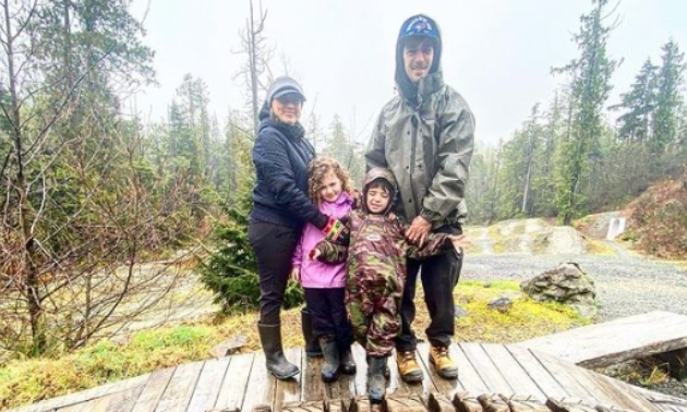 Perry family standing together in the woods