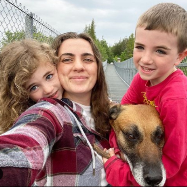 Perry family standing together in the woods